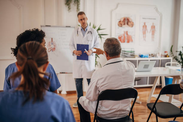 istock Group and nurses at lecture and meeting discussing medical case and learning innovative technique 1340690275