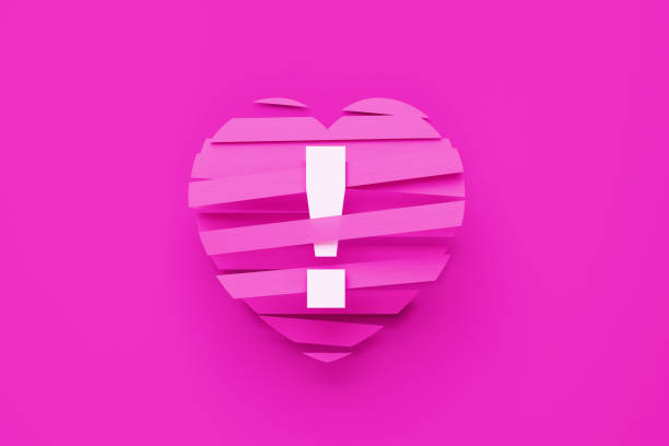 Exclamation point sitting pink ribbons over pink background. Horizontal composition with copy space. Love concept. Copy space available.