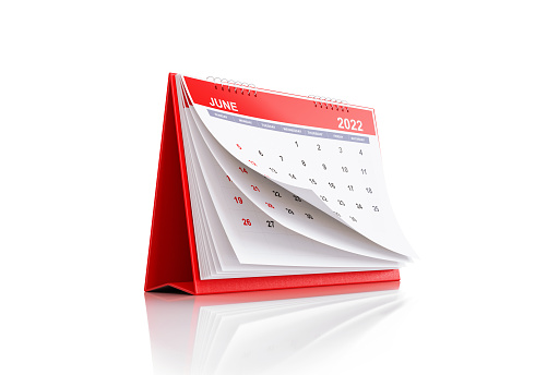 2022 Monthly Red Desk Calendar: June. Horizontal composition with copy space. Clipping path is included.  The calendar is red in color and standing on a white reflective background. Isolated on white.