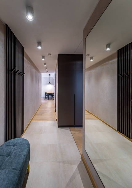 istock Modern interior of hallway in apartment. Mirror on wall. Grey wardrobe 1340695389