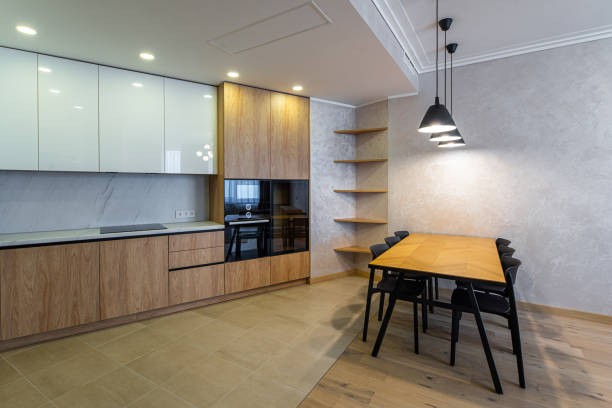istock Modern interior of spacious light wooden kitchen in apartment. 1340695391