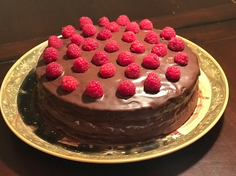 Homemade chocolate cake with raspberries on top