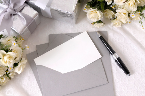 Writing paper or wedding invitation with envelope laid on bridal lace with several wedding gifts and white rose bouquets.  To see my complete collection of wedding backgrounds please CLICK HERE.   Alternative version of this file shown below: