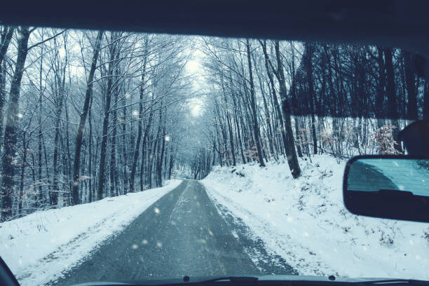istock Snowing on the road in winter time 1340698905
