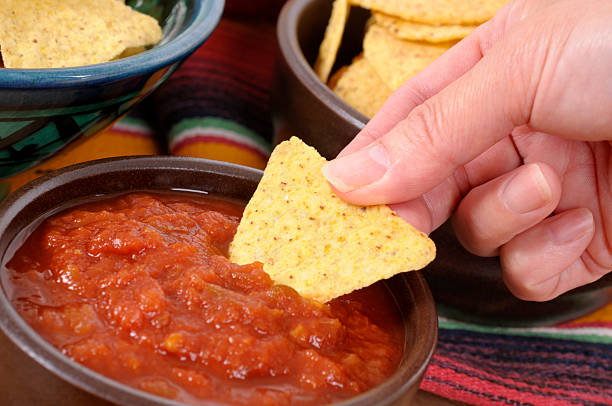 istock Mexican nachos and salsa with female hand 134069973