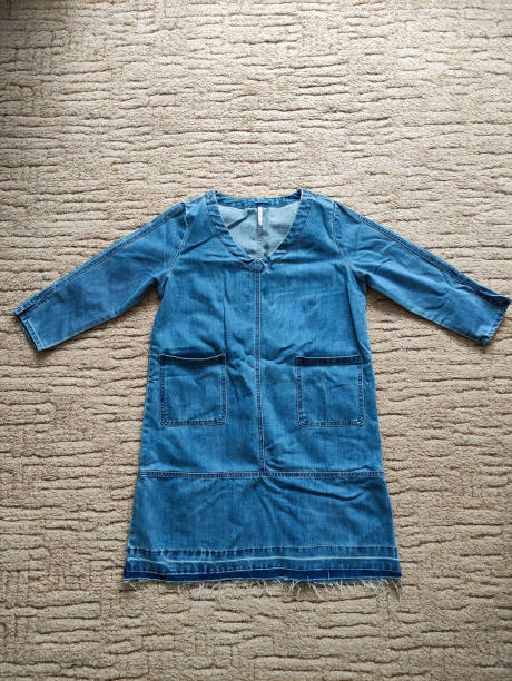 istock Beautiful denim dress on the carpet background 1340699788