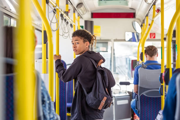 Teenage boy commuting in bus