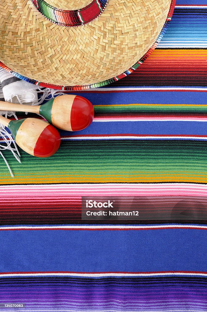 Mexican background with traditional blanket and sombrero Mexican background with traditional serape blanket, sombrero and maracas.  To see my complete Mexican collection please CLICK HERE.   Alternative horizontal version of this picture shown below: Backgrounds Stock Photo