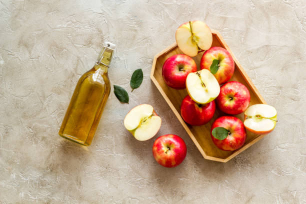 istock Apple cider vinegar in glass bottle with fresh red apples 1340701789
