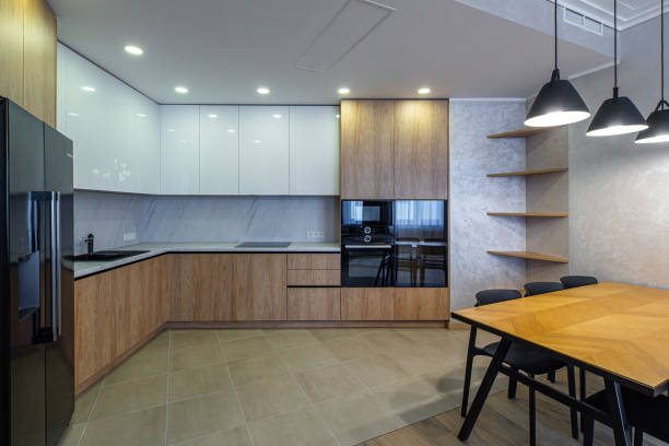 istock Modern interior of spacious light wooden kitchen in apartment. 1340702030
