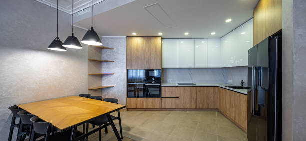 istock Modern interior of spacious light wooden kitchen in apartment. 1340702032