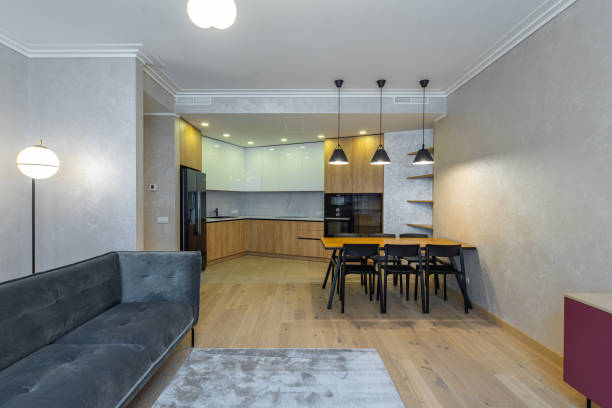 istock Modern interior of studio apartment. Wooden and black kitchen. Sofa. 1340702037