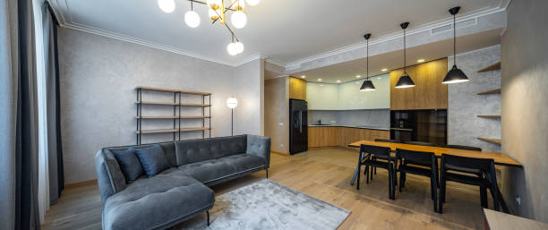 istock Modern interior of studio apartment. Wooden and black kitchen. Sofa. 1340702044