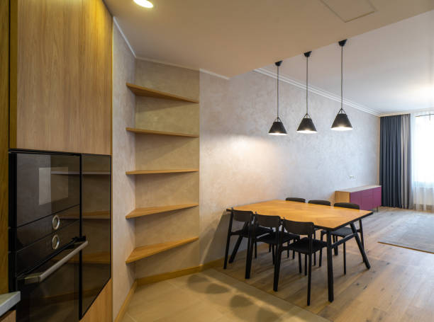 istock Modern interior of spacious light wooden kitchen in apartment. 1340702049