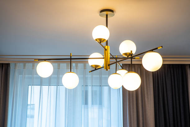 istock Modern designed chandelier with burning lamps. Contemporary interior. 1340702589