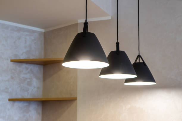 istock Close-up of black lamps on ceiling. Modern interior. 1340702598