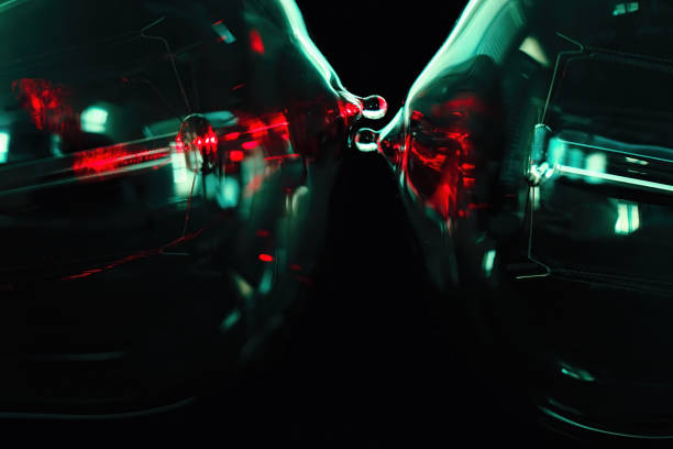 istock Glowing lightbulbs in macro view with vibrant red and teal higlights on black background 1340704655