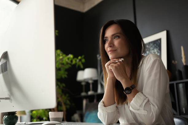 istock Attractive young woman working at office, using contemporary desktop computer. 1340705187