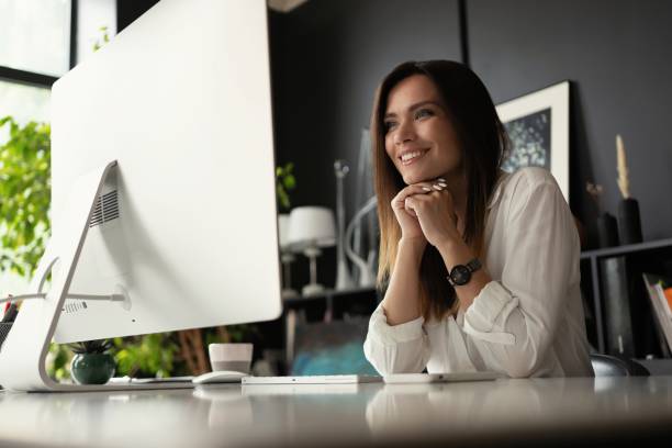 istock Attractive young woman working at office, using contemporary desktop computer. 1340705190
