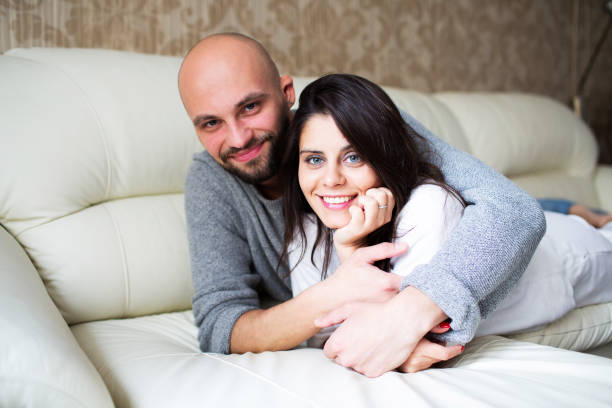 istock Young couple lying on the sofa at home 1340706195