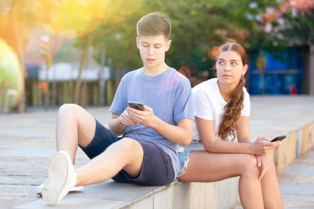 istock Two young people with mobile phones 1340706896