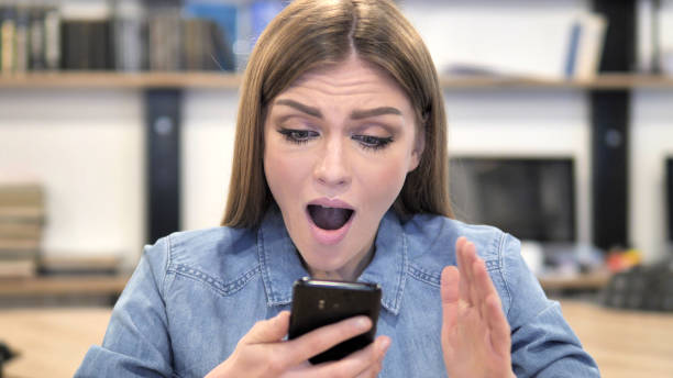 istock Young Woman Excited for Success while Using Smartphone 1340707210
