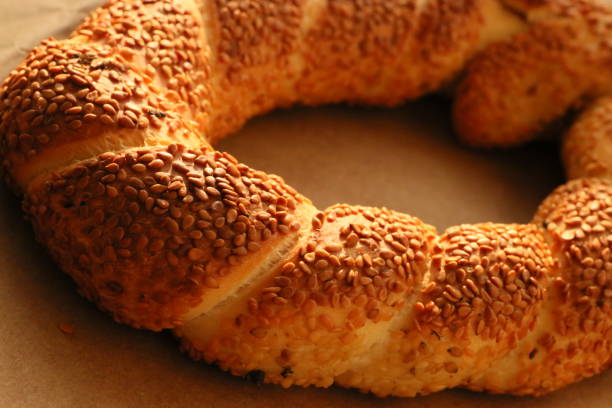istock Turkish crispy bagel with sesame seeds on brown wrapping paper 1340708566
