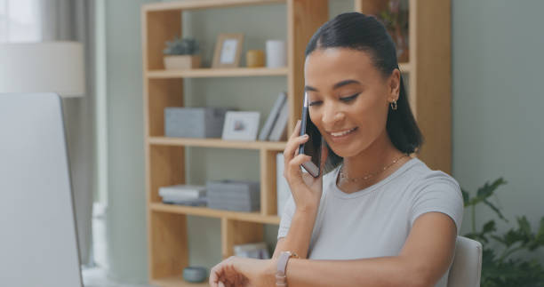 istock Shot of a young woman using a phone while checking the time at home 1340709059