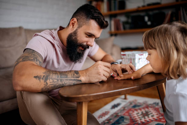 padre che dipinge chiodi alla sua bambina - padre single foto e immagini stock