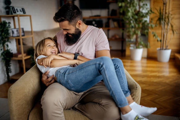 istock Father playing tickle games with his daughter 1340710386