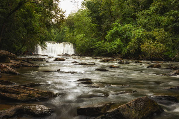 istock beautiful waterfall flowing into the riverbed 1340710836