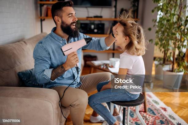 Young Bearded Single Father Drying His Daughters Hair In Domestic Room Stock Photo - Download Image Now