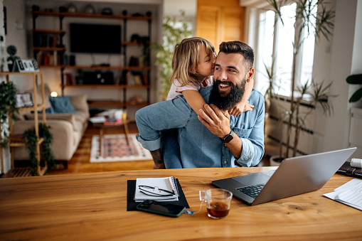 Working father bonding with his daughter