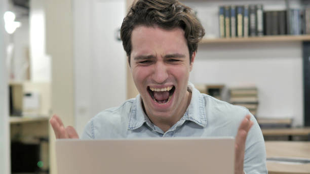 istock Angry Creative Man Screaming while Reacting to Loss 1340713812