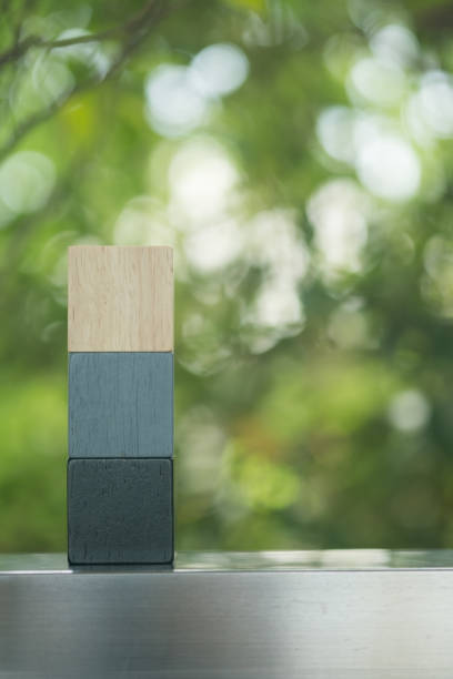 Different three colour wood block pile against nature background