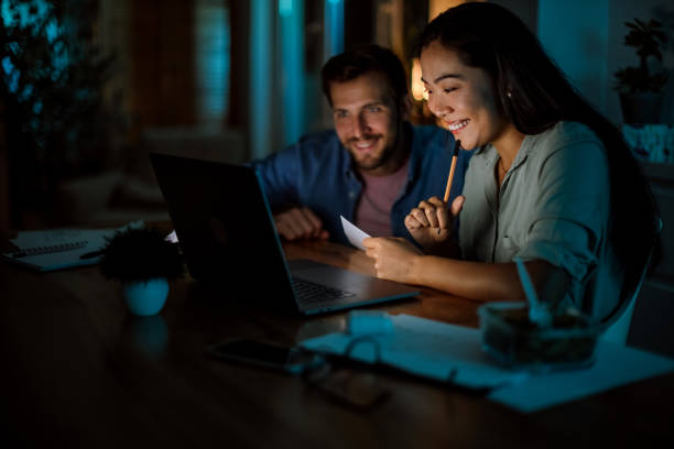istock Happy smiling people working late from home 1340715391