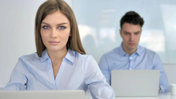 istock Young Businesswoman Looking at Camera in Office 1340715413