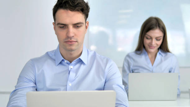 istock Young Businessman Working on Laptop in Office 1340716273
