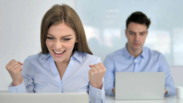 istock Excited Businesswoman Celebrating Success while Working on Laptop 1340716596