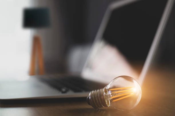 istock Laptop and glowing light bulb. Self learning or education knowledge and business studying concept. Idea of learning online or e-learning from home. 1340717564