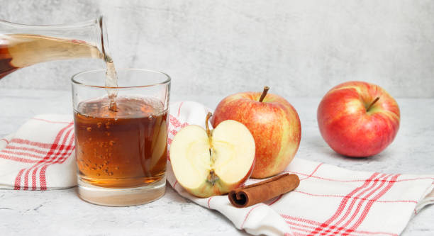 istock Banner with apple juice pouring in the glass 1340717596