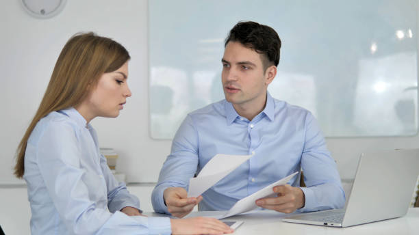 istock Businessman Discussing Documents with Partner, Business Loss 1340717612