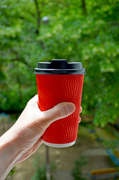 istock red paper cup with hot tea or coffee in a man's hand 1340717648