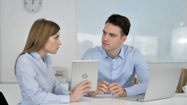 female business colleague demonstrating new plan on tablet - 18639 imagens e fotografias de stock