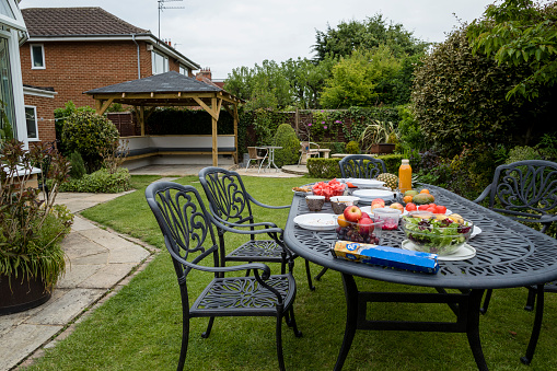 Table set in a garden in Middlesborough North East of England. There are healthy foods on the table such as salad, vegetables, fruits, juice.