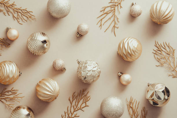 istock Christmas flat lay composition with golden balls and Xmas tree branches on beige background. Flat lay, top view. 1340720565