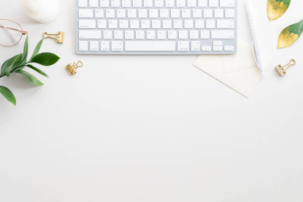 istock Office working desk with keyboard, plate, candle, accessories on white. Elegant feminine workspace. Creative flat lay composition. 1340720866