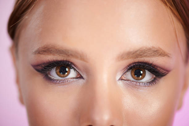 Clean makeup on woman face close up view. Brown woman eyes
