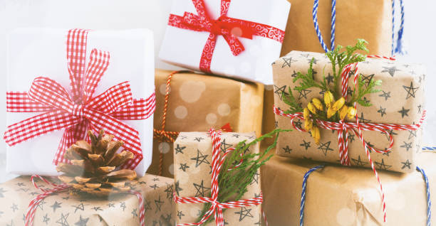 istock Colorful wrapped gift boxes with presents on white textured background. Selective focus.Place for text. 1340724750