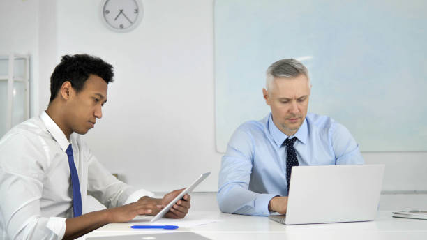 istock Business People Working on Tablet and Laptop, Multi Ethnic 1340726108